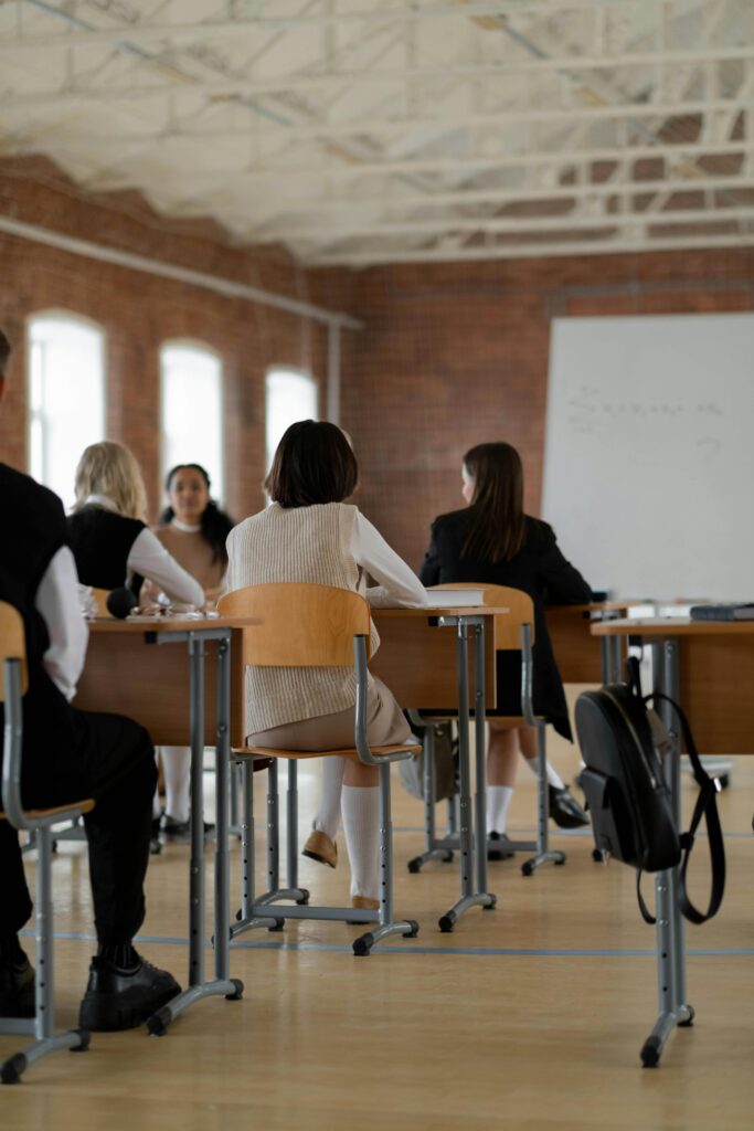 students sitting at desks in a big hall