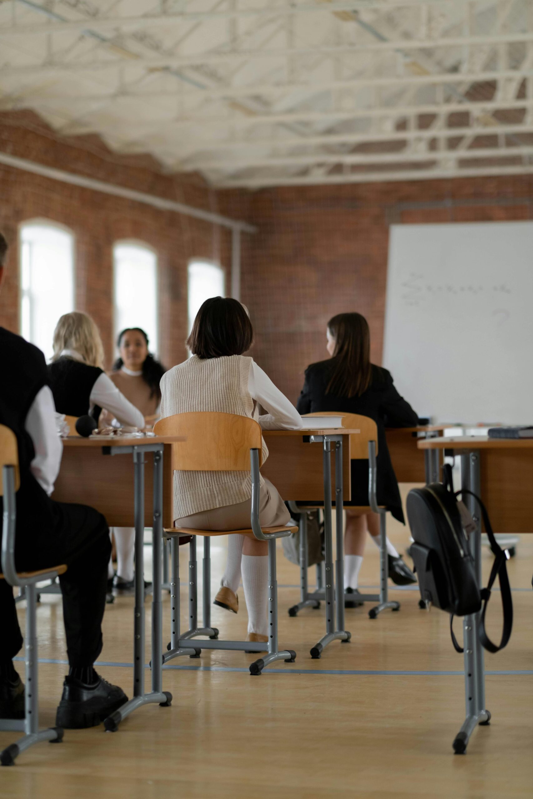 students sitting at desks in a big hall